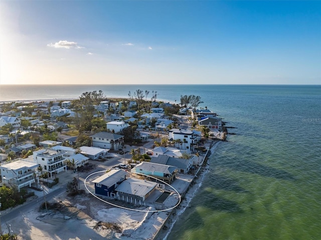 birds eye view of property featuring a water view and a view of the beach