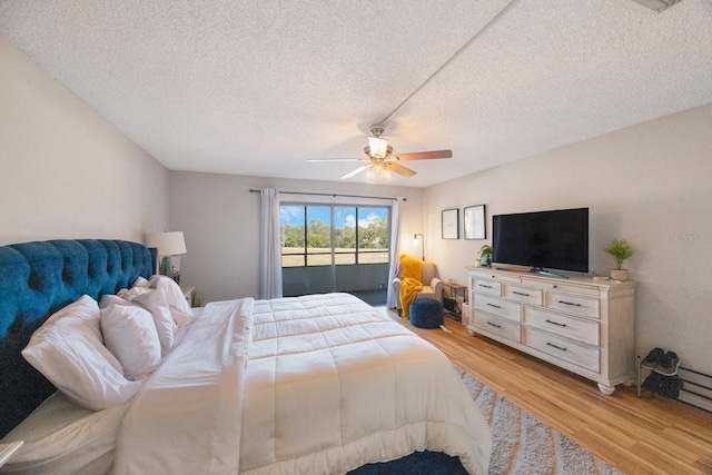 bedroom with access to exterior, a textured ceiling, light wood-type flooring, and ceiling fan