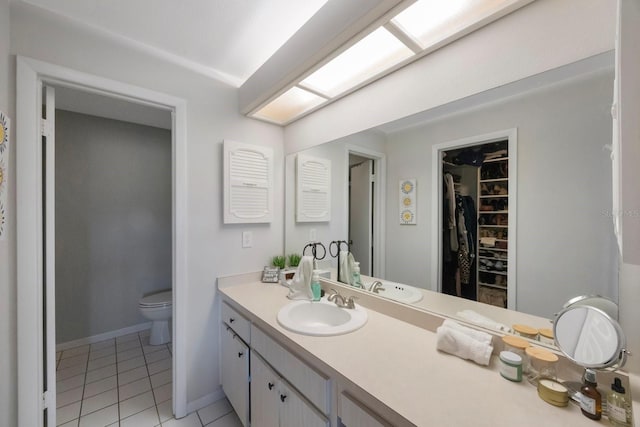 bathroom featuring tile patterned floors, vanity, and toilet