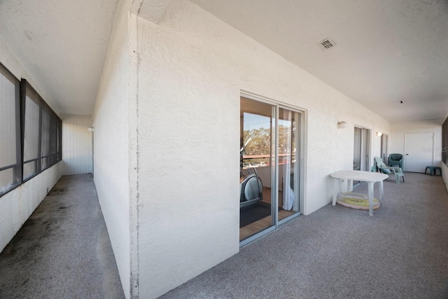 view of patio featuring a balcony