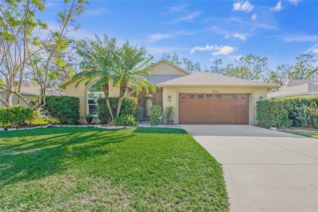 view of front of home with a garage and a front lawn