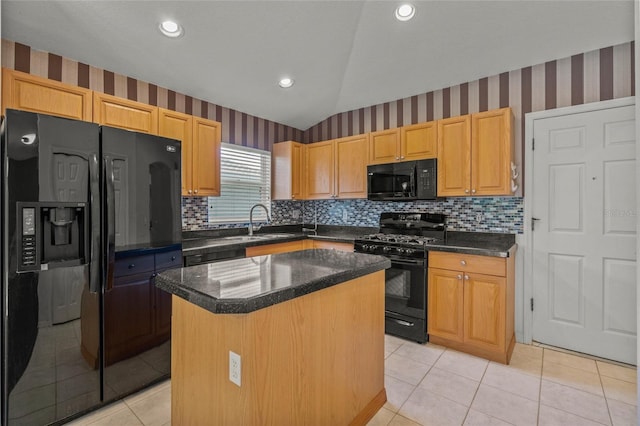 kitchen with sink, light tile patterned floors, vaulted ceiling, a kitchen island, and black appliances