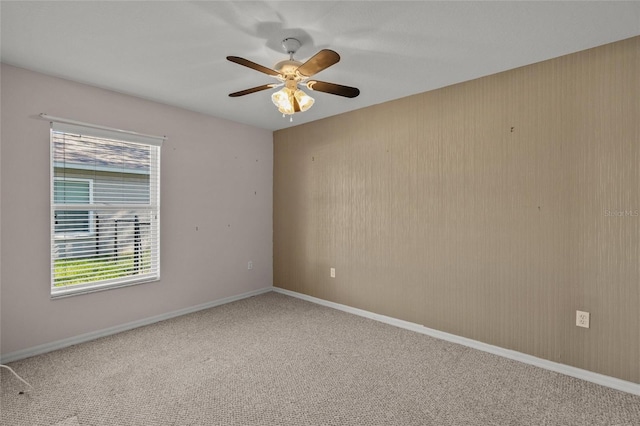 spare room featuring ceiling fan and carpet floors