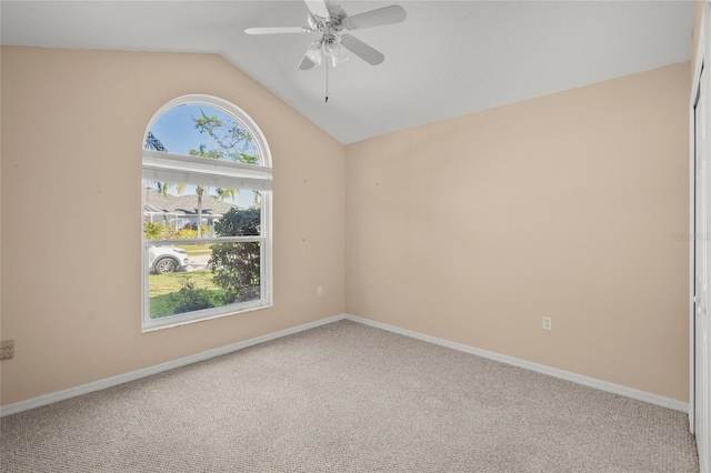 carpeted empty room with ceiling fan and vaulted ceiling