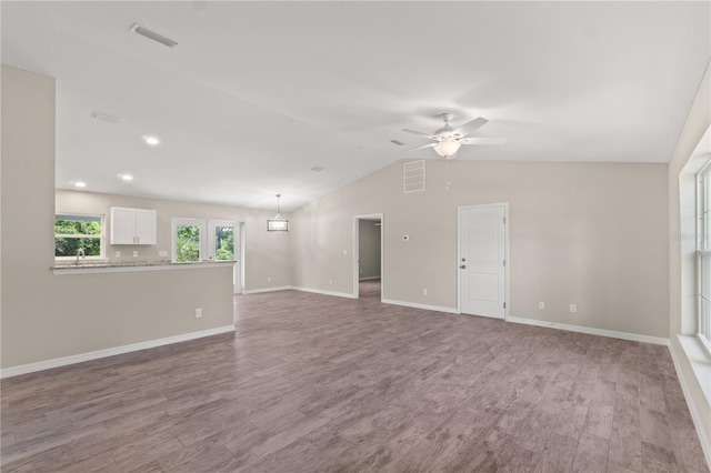 spare room with ceiling fan, hardwood / wood-style floors, vaulted ceiling, and sink