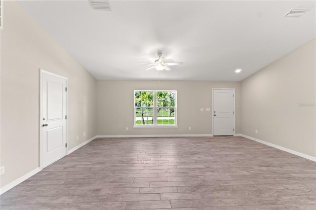 unfurnished room with light wood-type flooring and ceiling fan