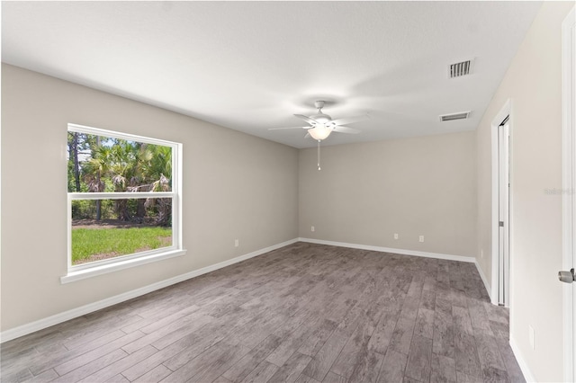 empty room featuring hardwood / wood-style flooring and ceiling fan