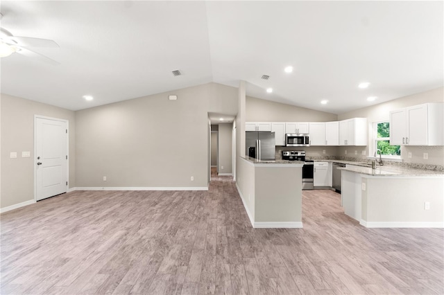 kitchen with appliances with stainless steel finishes, light wood-type flooring, vaulted ceiling, ceiling fan, and white cabinets