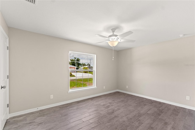 spare room with hardwood / wood-style flooring and ceiling fan