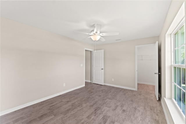 empty room featuring ceiling fan and light hardwood / wood-style flooring