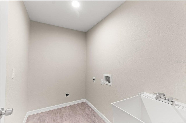 laundry area featuring hookup for a washing machine, sink, hardwood / wood-style floors, and hookup for an electric dryer