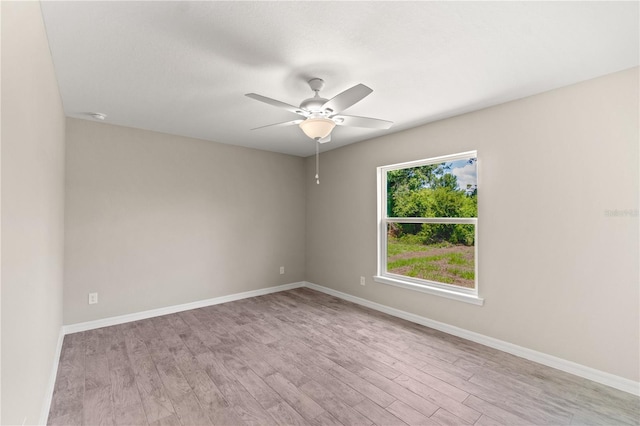 empty room featuring ceiling fan and light wood-type flooring