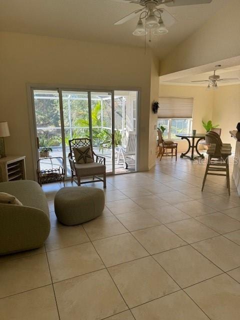 tiled living room with ceiling fan and vaulted ceiling