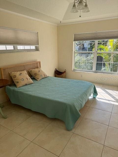 tiled bedroom with ceiling fan and crown molding