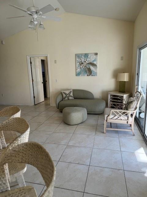 tiled living room with ceiling fan and vaulted ceiling