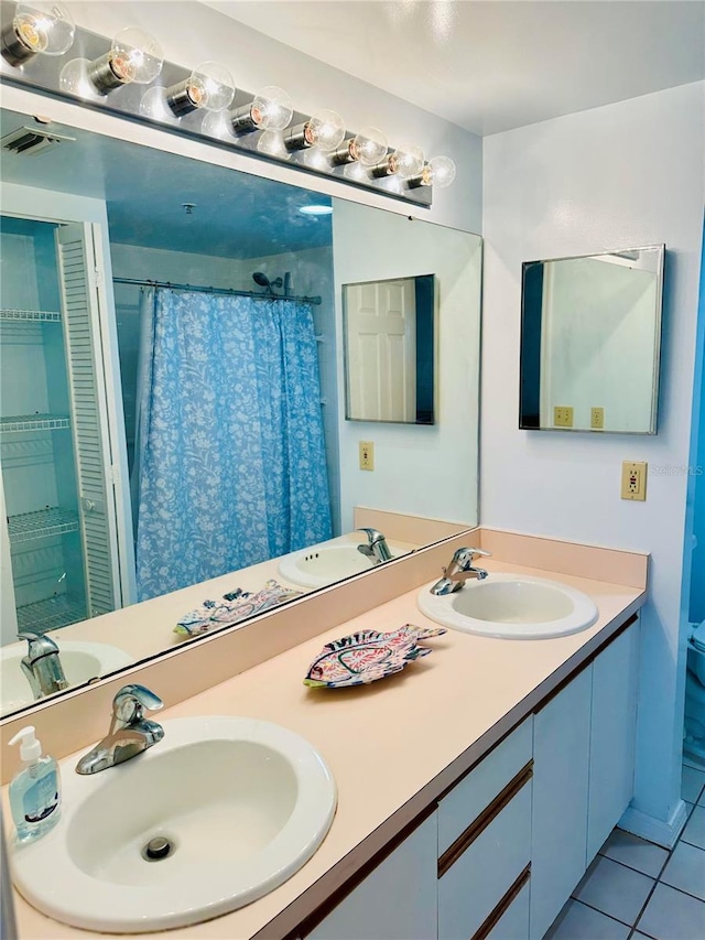 bathroom featuring tile patterned flooring and vanity