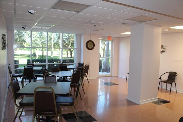 dining space with a paneled ceiling