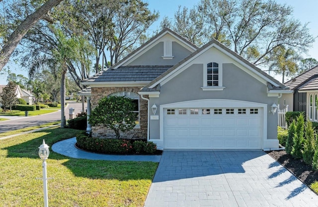 view of front of home with a front yard and a garage