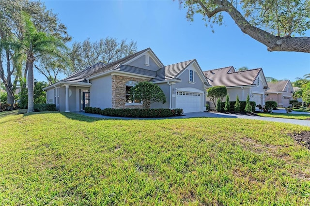 view of front of property featuring a garage and a front lawn