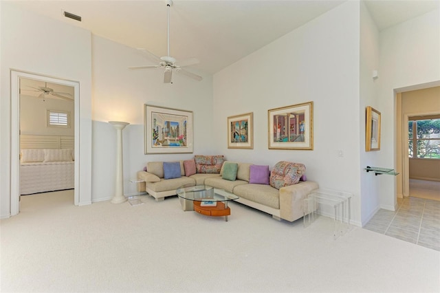 living room with light carpet, high vaulted ceiling, and decorative columns