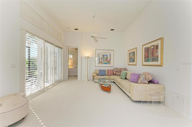 carpeted living room featuring ceiling fan