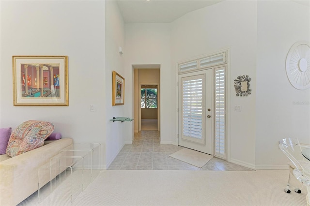 foyer featuring a high ceiling and light tile patterned flooring