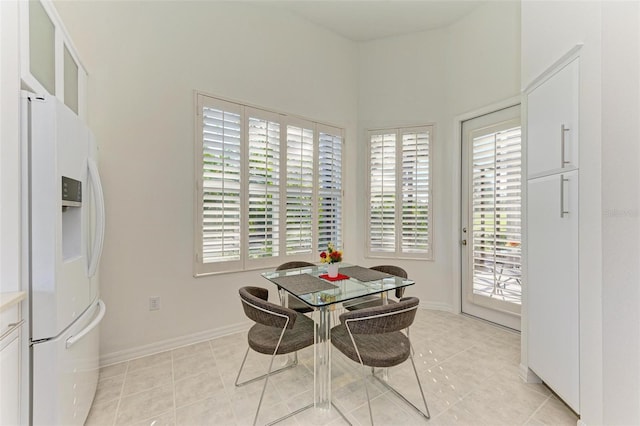 dining space with a wealth of natural light and light tile patterned floors