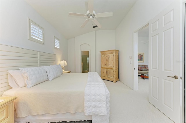 carpeted bedroom with vaulted ceiling and ceiling fan