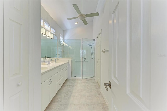 bathroom with ceiling fan, walk in shower, tile patterned flooring, lofted ceiling, and vanity