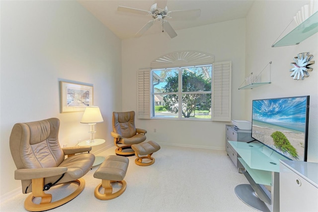 living area with carpet flooring, vaulted ceiling, and ceiling fan