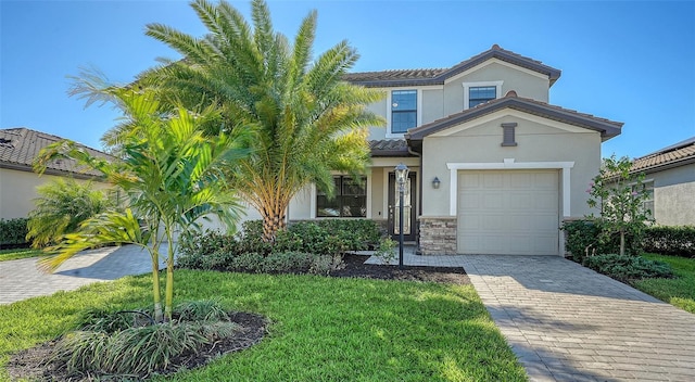 view of front of home with a garage and a front lawn