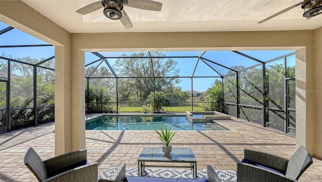 view of pool with an in ground hot tub, a patio, ceiling fan, and a lanai