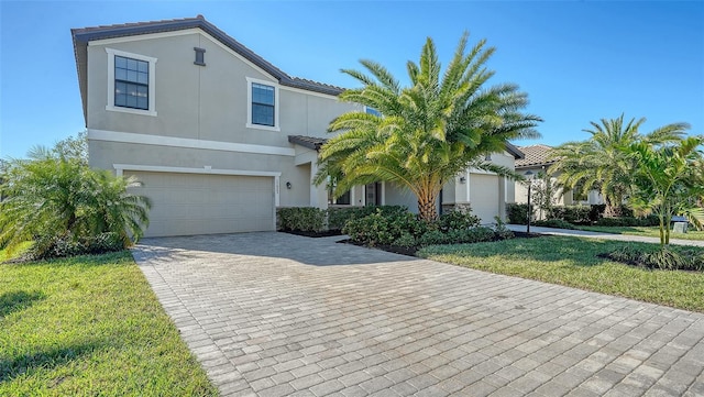 view of front of home with a garage and a front lawn