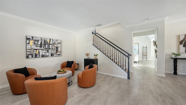 sitting room with light hardwood / wood-style flooring and ornamental molding