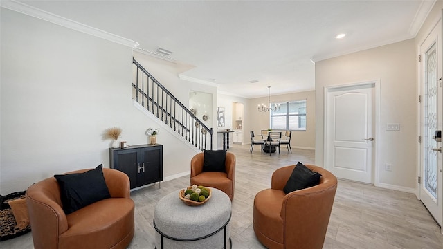 living room featuring a notable chandelier, light wood-type flooring, and ornamental molding