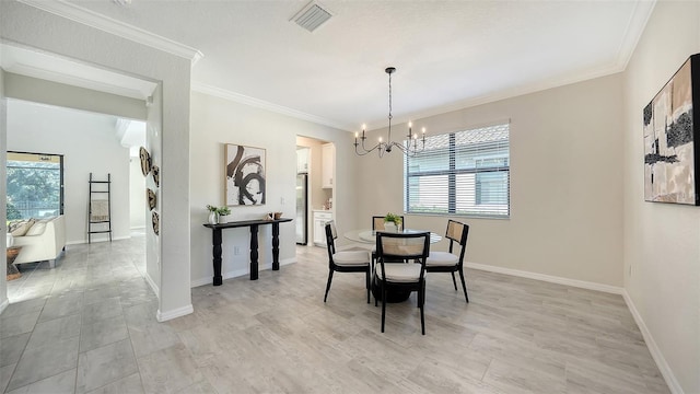 dining room featuring light hardwood / wood-style flooring, crown molding, and a chandelier