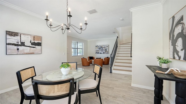 dining area with light wood-type flooring, crown molding, and a notable chandelier