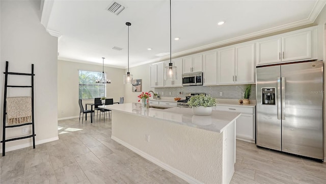 kitchen with sink, decorative light fixtures, a center island with sink, white cabinets, and appliances with stainless steel finishes