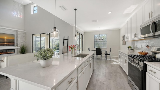 kitchen with white cabinetry, sink, an island with sink, and appliances with stainless steel finishes