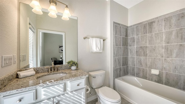 full bathroom featuring vanity, toilet, and tiled shower / bath