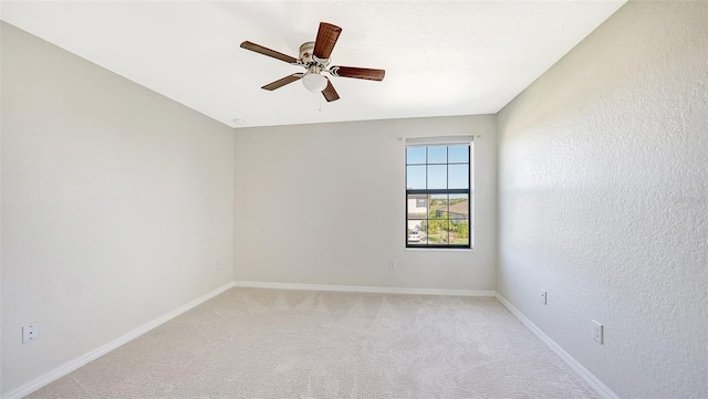 unfurnished room featuring light carpet and ceiling fan