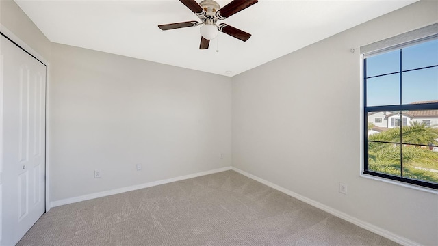 empty room with carpet flooring and ceiling fan