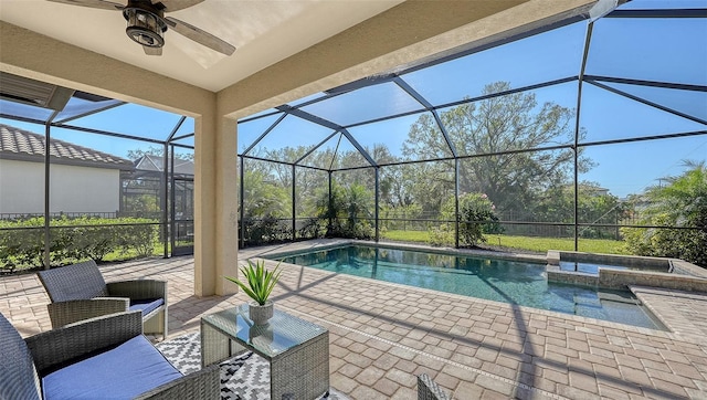 view of swimming pool with a lanai, ceiling fan, and a patio