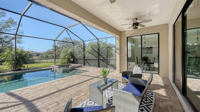 view of pool with a lanai, ceiling fan, a patio area, and an in ground hot tub