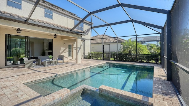 view of swimming pool featuring a lanai, ceiling fan, a patio, and an in ground hot tub