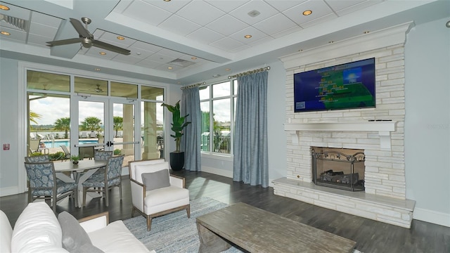 living room with a fireplace, french doors, dark hardwood / wood-style flooring, and ceiling fan