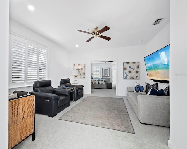 living room featuring carpet flooring and ceiling fan