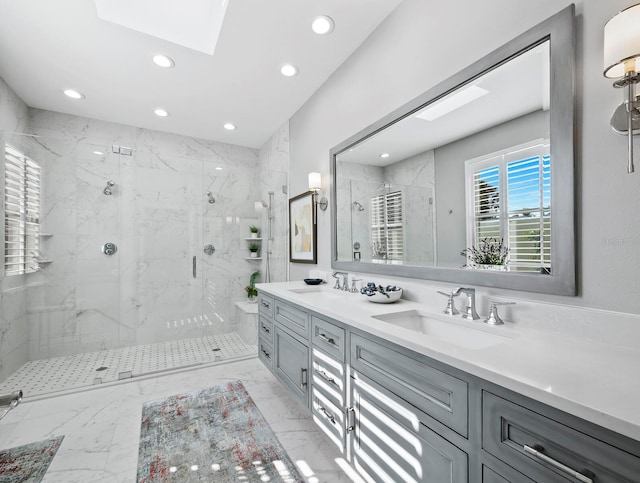 bathroom with vanity, an enclosed shower, and a skylight