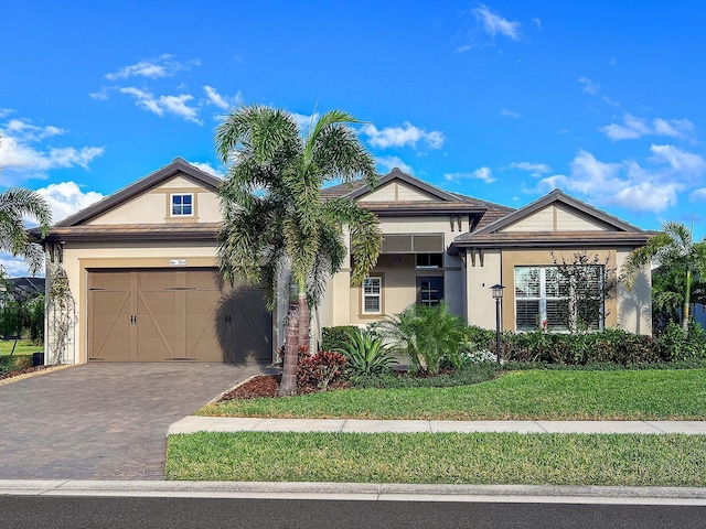 view of front facade with a front yard and a garage