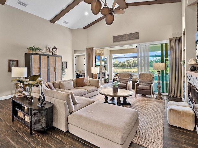 living room featuring beam ceiling, ceiling fan, and a high ceiling